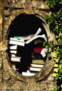 Books by Graham Hiscock Books stacked in round concrete window